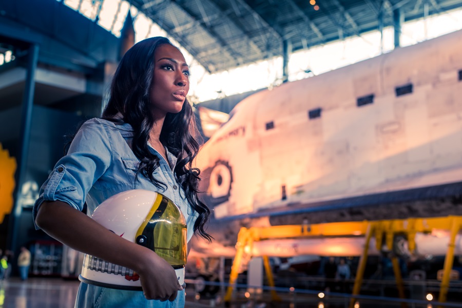 Aisha Bowe at museum with rocket ships