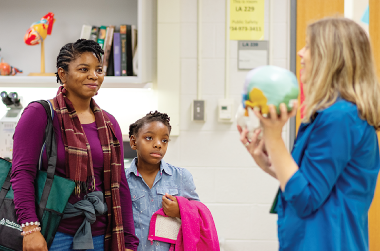 Gwen Hooks and her daughter, Jocelyn, of Belleville, observe Washtenaw Community College faculty member Susan Dentel during her Free College Day class, “Behind the Scenes: A Backstage Pass to the STEM Labs.” (Photo by CJ South)
